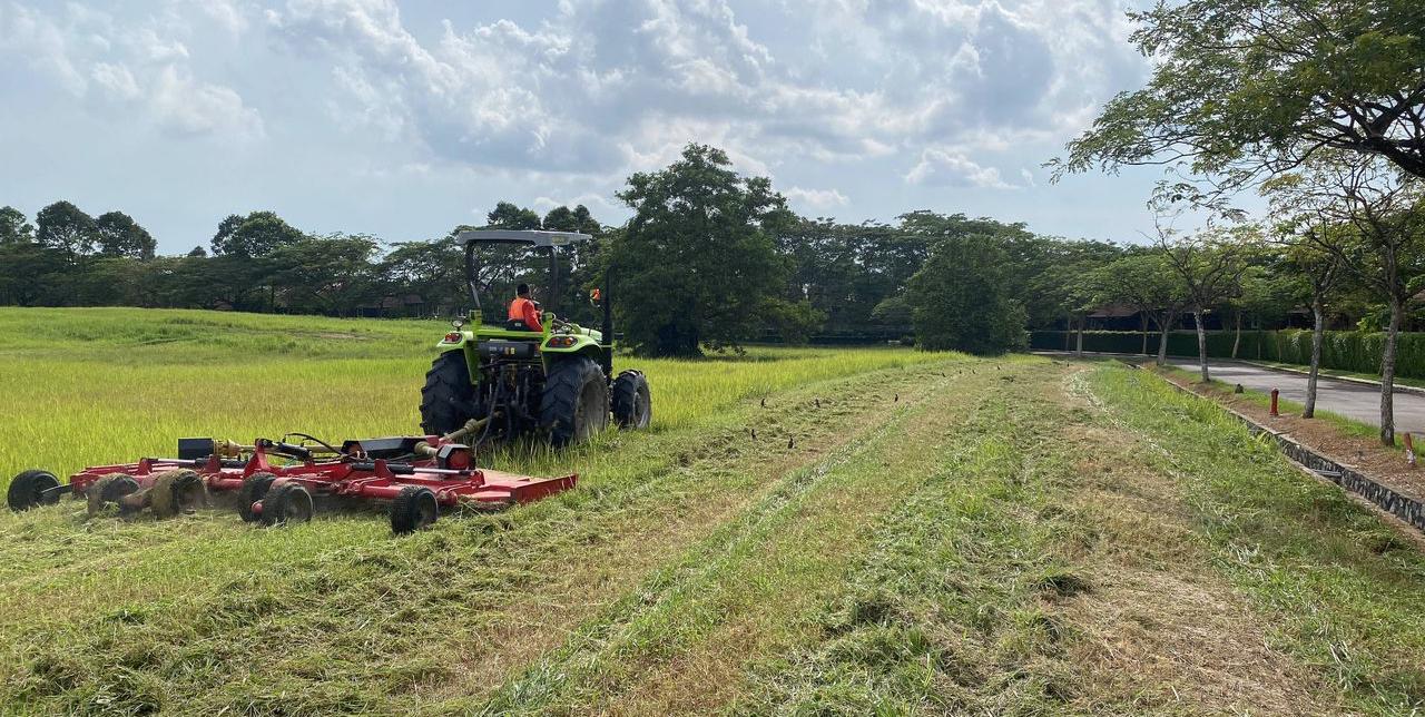 Tractor mowing large grass area