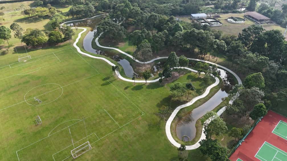 Aerial view of township park with jogging track and lake